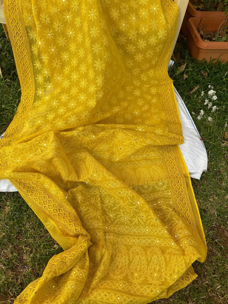 yellow doria kota chikankari saree with mirror work and lace edging