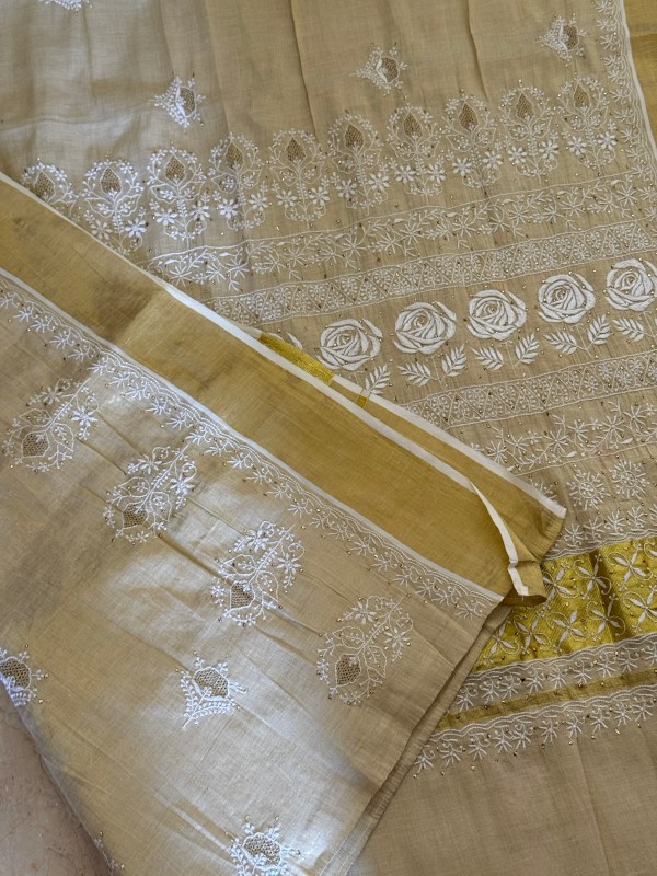Off-white Kerala Kasavu saree with Chikankari & Jaali work motifs.