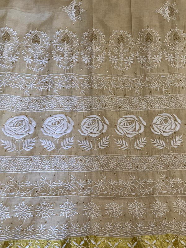 Off-white Kerala Kasavu saree with Chikankari & Jaali work motifs.